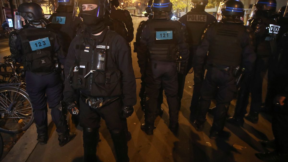 Police officers face demonstrators during a rally on the Place de La Republique, Tuesday, Nov.24, 2020 in Paris.