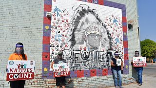 Activists hold signs promoting Native American participation in the U.S. census of 2020.