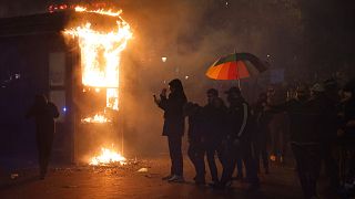 A shop burning during a demonstration against the 'global security' draft law