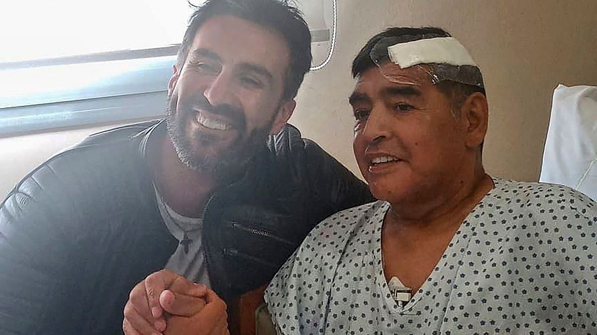 Argentine football legend Diego Maradona (R) shaking hands with his doctor Leopoldo Luque in Olivos, Buenos Aires province, Argentina.