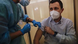 People receives flu vaccine at the Museum of science and technology in Milan, Italy, Wednesday, Nov. 4, 2020.