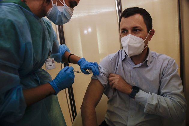 People receives flu vaccine at the Museum of science and technology in Milan, Italy, Wednesday, Nov. 4, 2020.