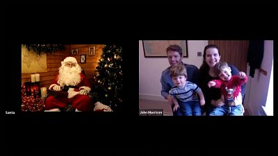 Santa speaking with children and their parents via video call