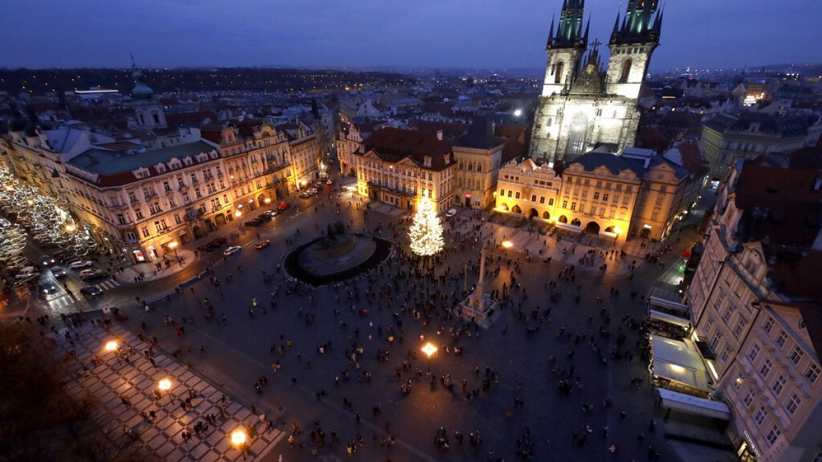 A Christmas tree illuminates the Old Town Square in Prague, Czech Republic, Saturday, Nov. 28, 2020. 
