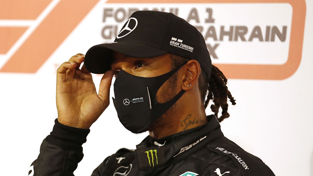 Mercedes driver Lewis Hamilton of Britain gestures after taking the pole position after the qualifying session Bahrain:  Saturday, Nov. 28, 2020 