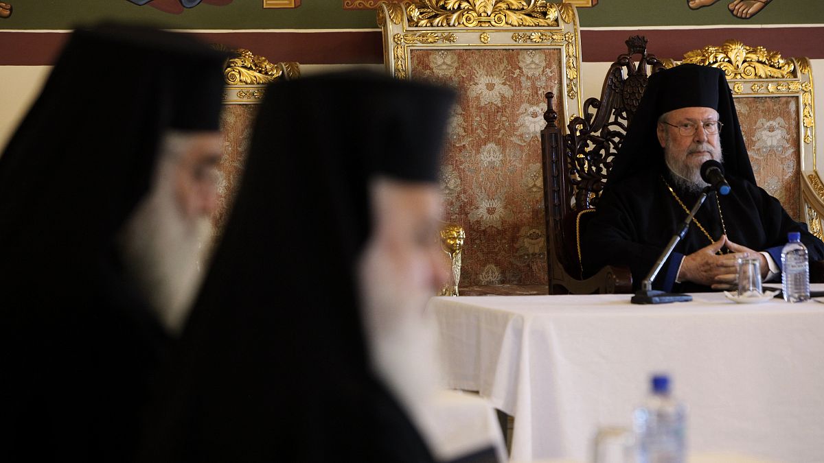 The head of Cyprus Orthodox Church Archbishop Chrysostomos II, right, presides over a meeting of other bishops composing the Holy Synod