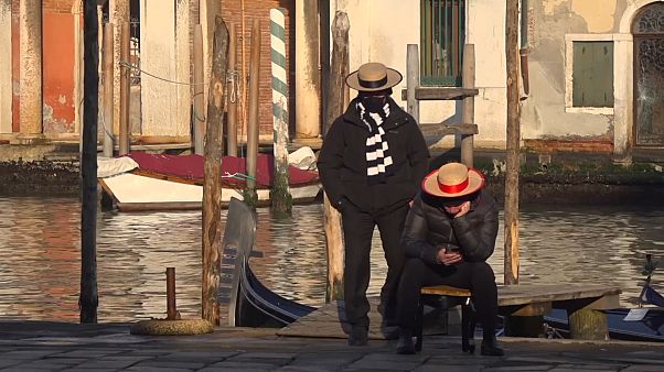 Two gondoliers waiting for clients Two gondoliers waiting for clients