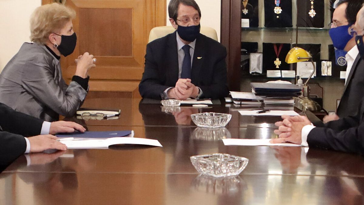 Cyprus President Nicos Anastasiades, center, United Nations Secretary General advisor Jane Holl Lute, left, and Cyprus' foreign minister Nicos Christodoulides, right, meet. 