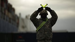 A U.S. soldier directs armoured vehicles and tanks of the 1st Armored Brigade Combat Team and 1st Calvary Division at the port of Antwerp, Belgium, Nov. 16, 2020.