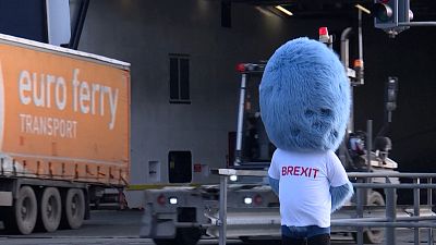'Brexit Monster' with lorries driving around the mascot