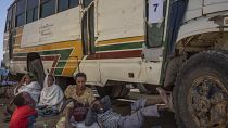 Tigray refugees wait to ride their bus going to Village 8 temporary shelter, near the Sudan-Ethiopia border, in Hamdayet, Dec. 1, 2020.