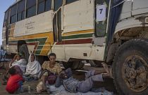 Tigray refugees wait to ride their bus going to Village 8 temporary shelter, near the Sudan-Ethiopia border, in Hamdayet, Dec. 1, 2020.
