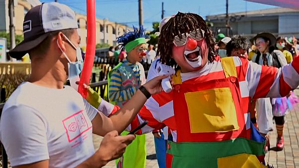 A participant in the clown day celebrations has his temperature checked A participant in the clown day celebrations has his temperature checked