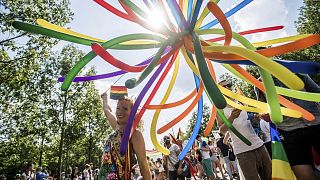 participants walk towards the Parliament building during the Pride March at the Budapest Pride LGBTQ Festival in Budapest, Hungary.