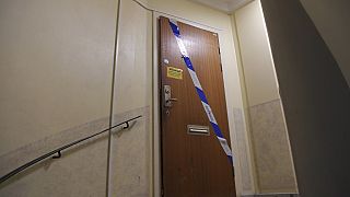 Police tape fixed on the door of the apartment in Haninge, south of Stockholm.