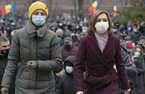 Moldova's president elect Maia Sandu, right, walks away after addressing protesters outside the parliament building in Chisinau, Moldova, Thursday, December 3, 2020.