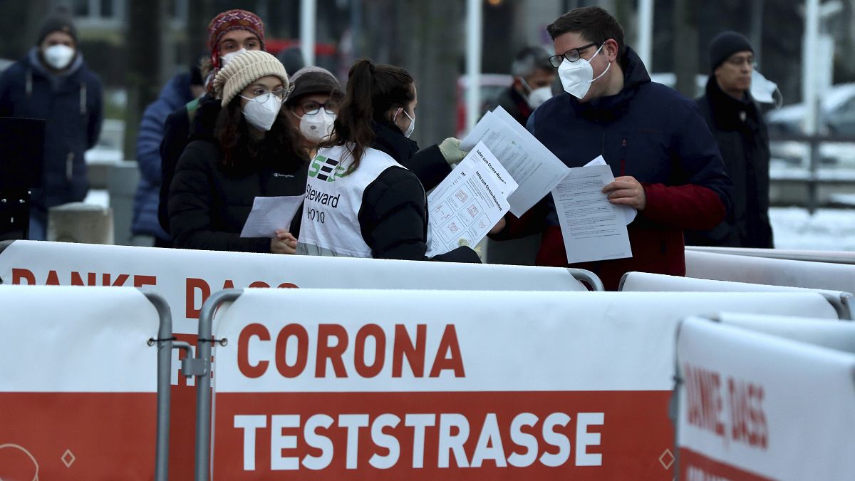 People line up a corona test street for a mass Covid-19 testing in Vienna, Austria