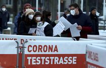 People line up a corona test street for a mass Covid-19 testing in Vienna, Austria