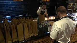 Employees at Wood Manchester prepare take-out meals