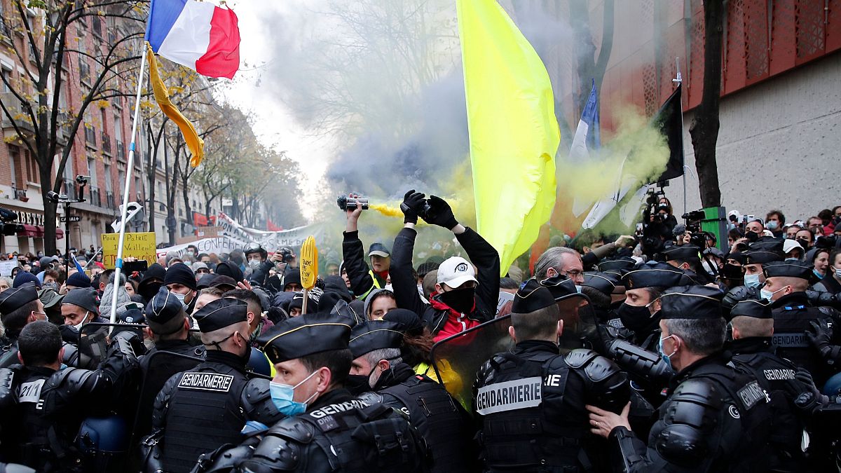 Protesters blocked by riot police during a demonstration Saturday, Dec. 5, 2020 in Paris