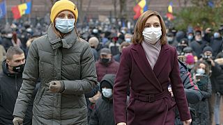 Moldovan President Maia Sandu, right, walks away after addressing protesters outside the parliament building in December 2020.