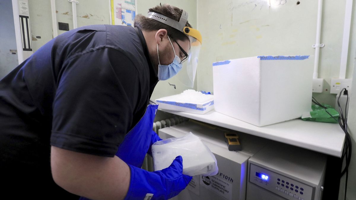 A pharmacy technician prepares to store the first delivery of COVID-19 vaccine, at Croydon University Hospital in Croydon, England, Saturday Dec. 5, 2020.