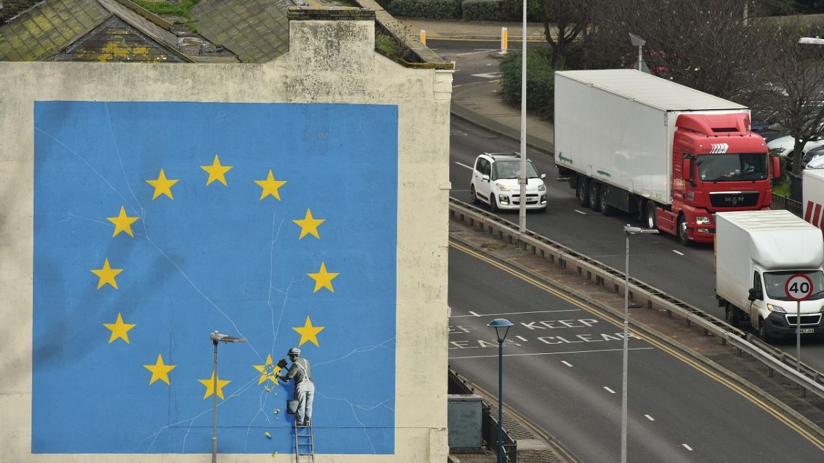 A mural by British artist Banksy, depicting a workman chipping away at one of the stars on an EU flag, is pictured in Dover, south east England on January 7, 2019.