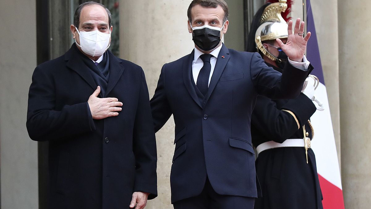 French President Emmanuel Macron, right, and Egyptian President Abdel-Fattah el-Siss gesture upon el-Sissi arrival at the Elysee palace, Monday, Dec. 7, 2020 in Paris