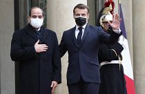 French President Emmanuel Macron, right, and Egyptian President Abdel-Fattah el-Siss gesture upon el-Sissi arrival at the Elysee palace, Monday, Dec. 7, 2020 in Paris
