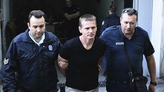 Греческая полиция конвоирует Александра Винника в Салониках 4 октября 2017