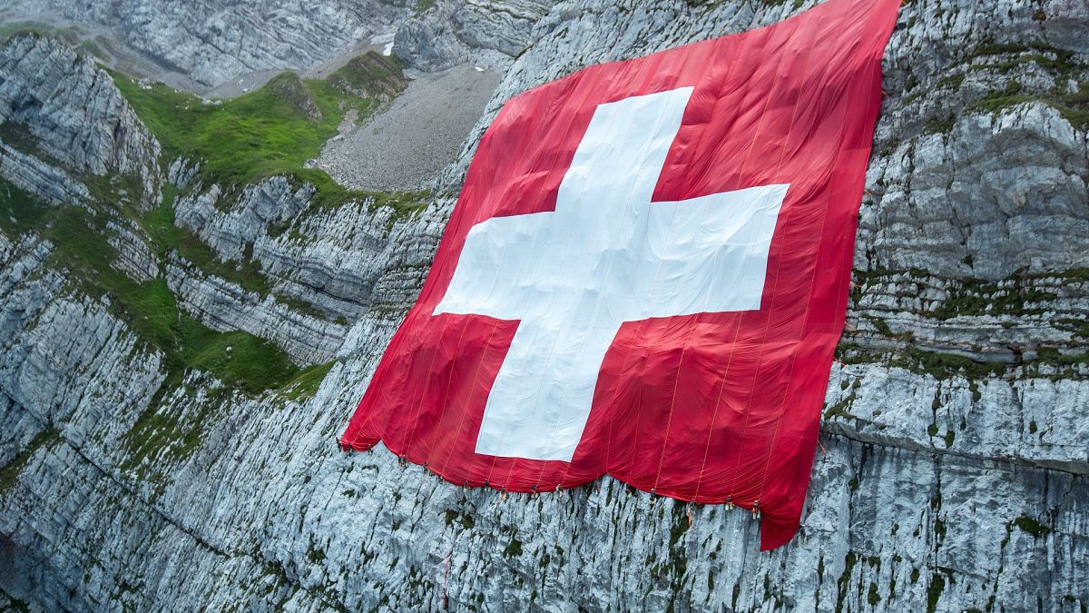 The Swiss flag on a rock face below the Saentis on Friday, July 31, 2020
