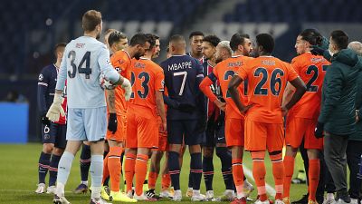 Players of Paris Saint Germain and Istanbul Basaksehir leave the pitch after an argument between the Turkish players and the fourth referee during a Champions League game.