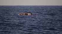 Migrants on a wooden boat in the Mediterranean