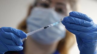 A nurse prepares to administer a dose of the Pfizer vaccine.