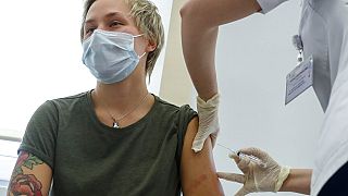 A Russian healthworker is among the first to receive the Sputnik V vaccine against COVID-19 on December 5, 2020.