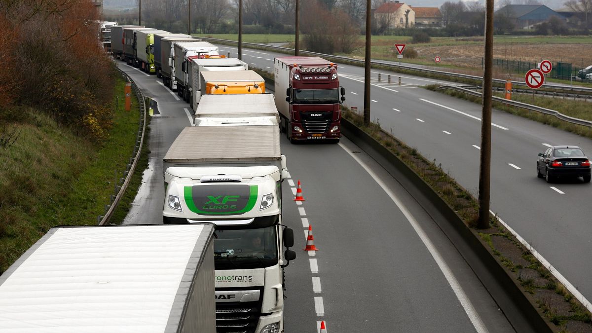 Lorries queue along the A16 motorway to board ferries to reach England, near Calais, northern France, Wednesday, Dec. 9 2020.