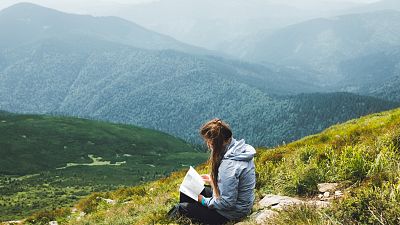Reading climate fiction on the top of a mountain Reading climate fiction on the top of a mountain