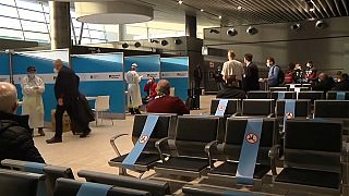 COVID-19 testing booths and passengers queuing