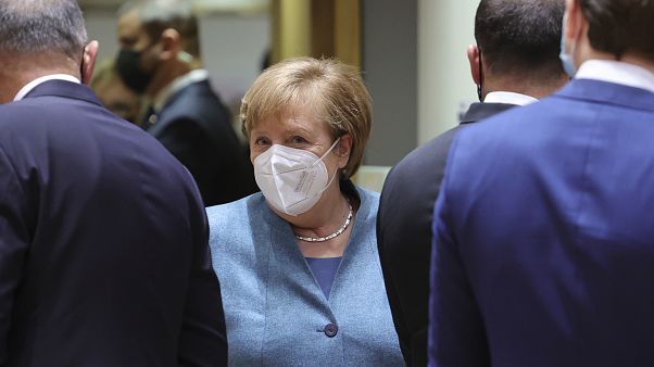 German Chancellor Angela Merkel, center, arrives for a round table meeting at an EU summit at the European Council building in Brussels, Thursday, Dec. 10, 2020. 