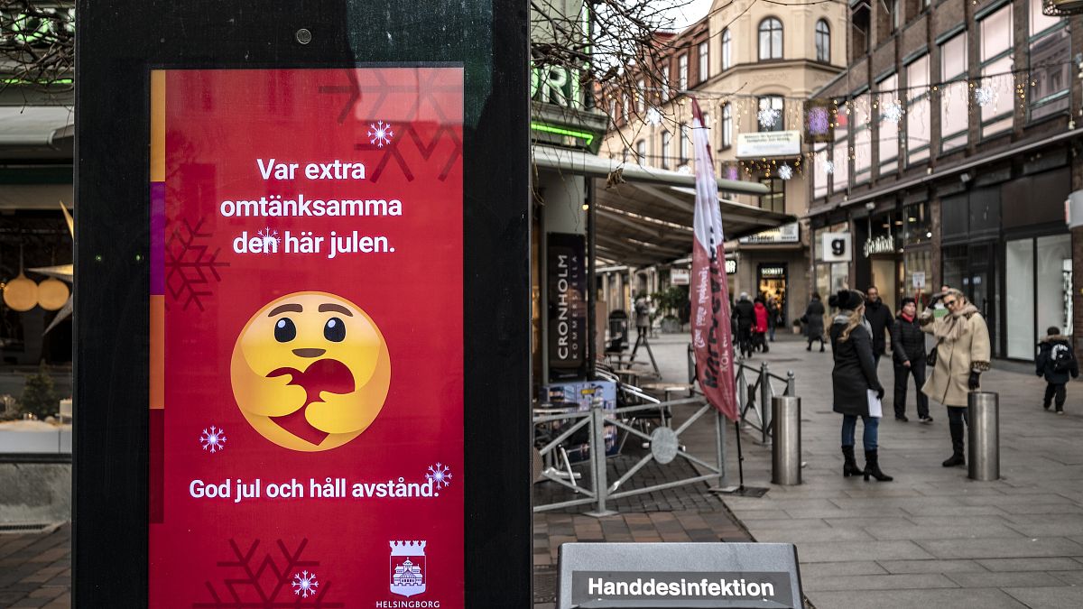 An public information sign wishing Merry Christmas and asking to maintain social distancing is seen in a pedestrian shopping street in Helsingborg, Sweden, Dec. 7, 2020. 