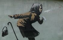 Sneezing woman artwork by British artist Banksy appears on Bristol house