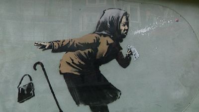 Sneezing woman artwork by British artist Banksy appears on Bristol house