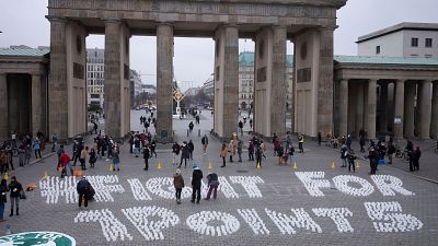 Students set up candles for the slogan'Fight for 1 point 5' during a protest of the Fridays For Future movement at the Brandenburg Gate Berlin, Germany