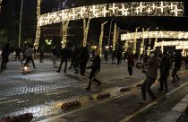 Protesters throw stones to riot police during clashes in Tirana