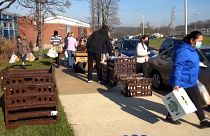People walking away carring food parcels