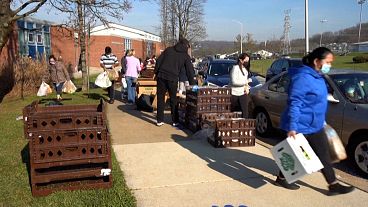 People walking away carring food parcels