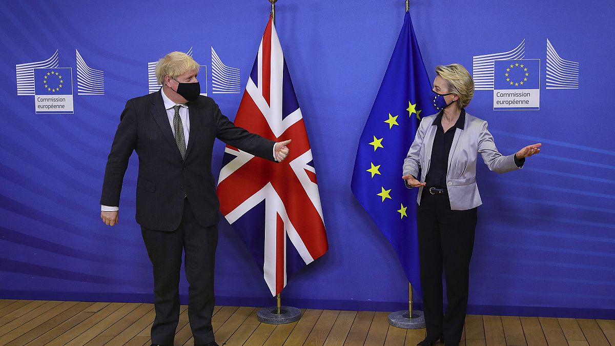 Britain's Prime Minister Boris Johnson is welcomed for a dinner with European Commission president Ursula von der Leyen, right, in Brussels, Belgium, Wednesday Dec. 9, 2020.