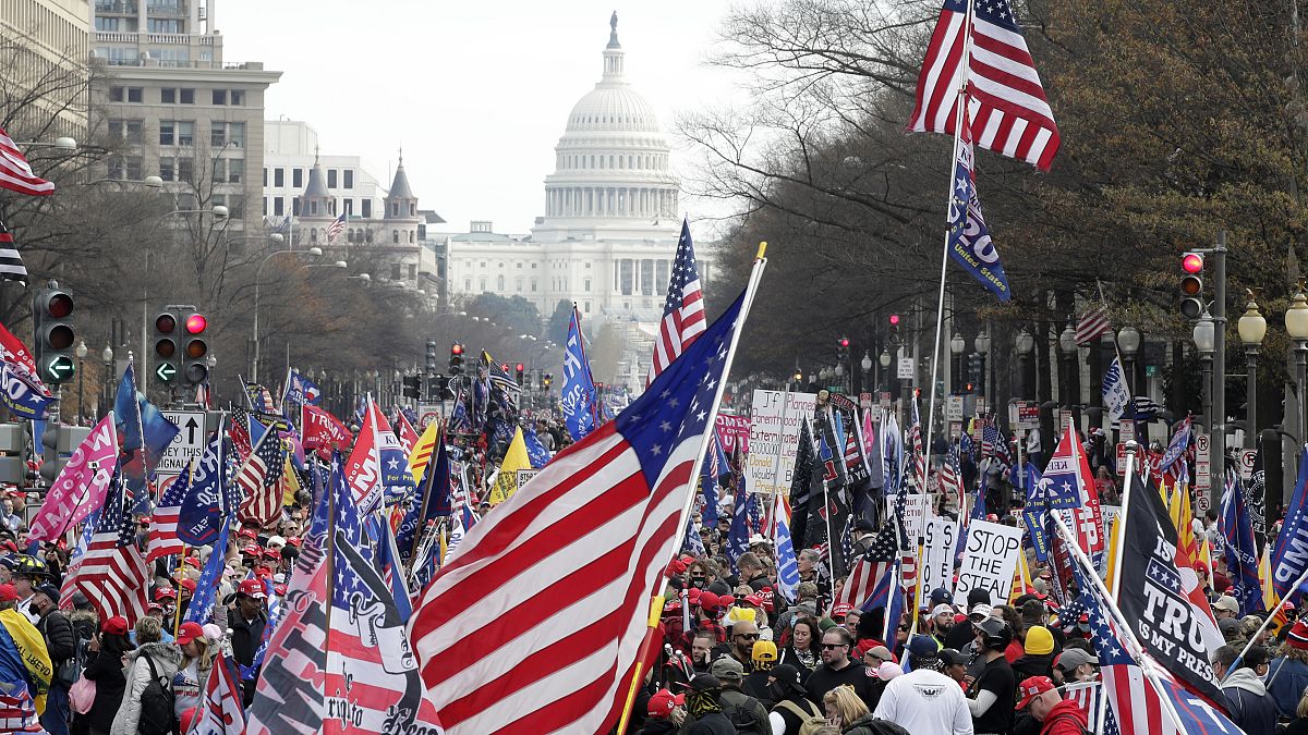 With the U.S. Capitol building in the background, supporters of President Donald Trump stand Pennsylvania Avenue during a rally at Freedom Plaza, Saturday, Dec. 12, 2020.