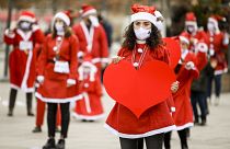 People dressed as Santa Claus take part in a charity event in Pristina.