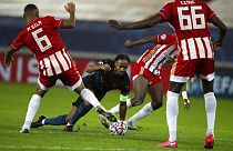 Manchester City's Raheem Sterling, centre, challenges for the ball with three Olympiakos players
